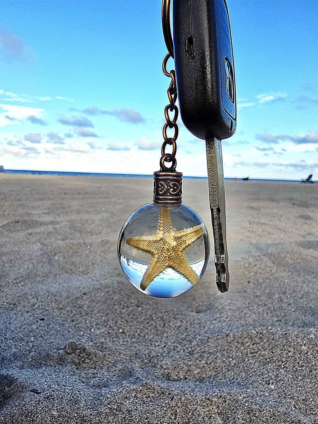 Sea Star of Atlantis resin orb keychain clipped to keys