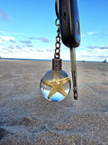 Sea Star of Atlantis resin orb keychain clipped to keys
