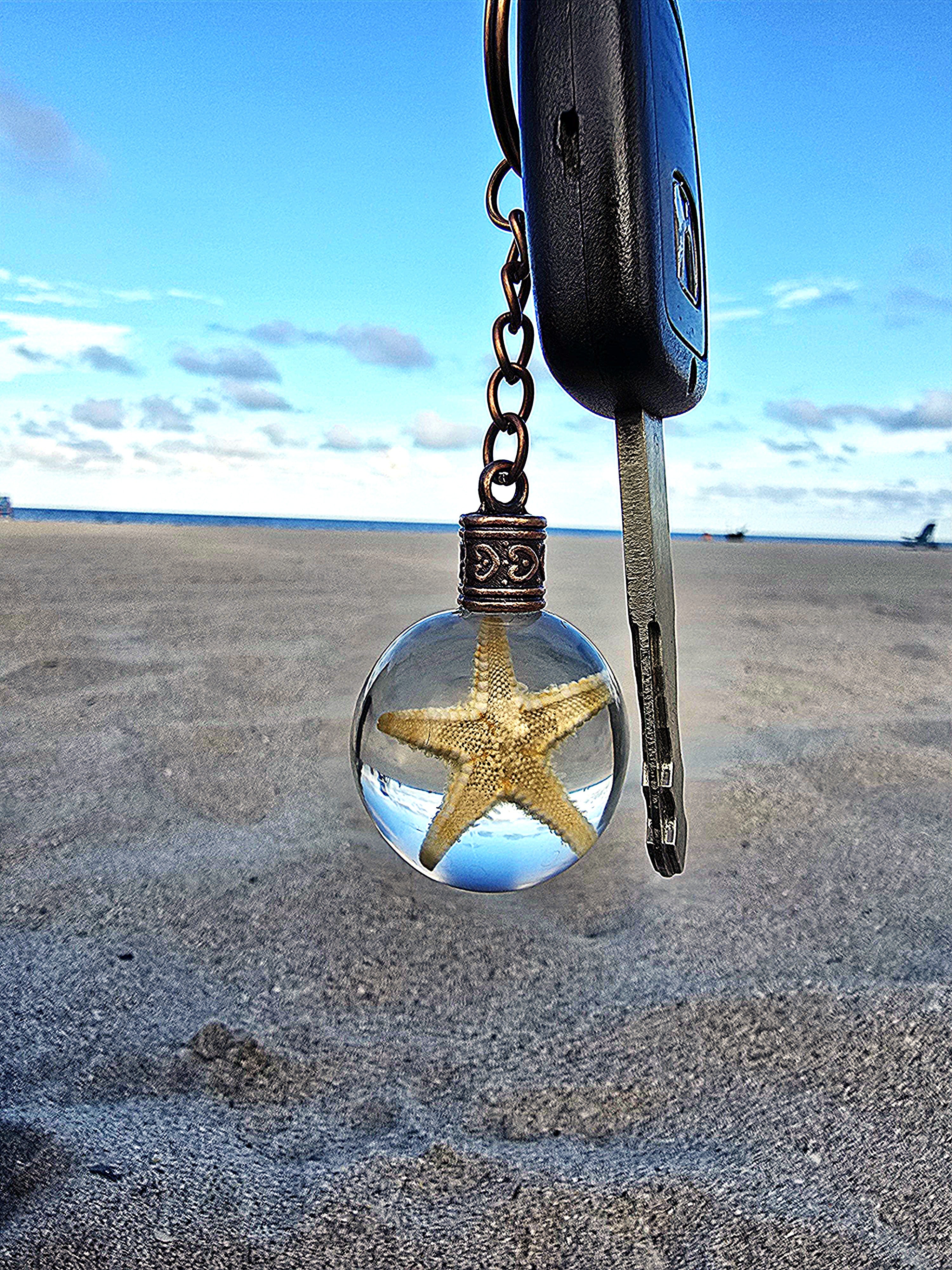 Sea Star of Atlantis resin orb keychain clipped to keys